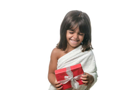 Happy little girl with a gift on white backgroundの写真素材