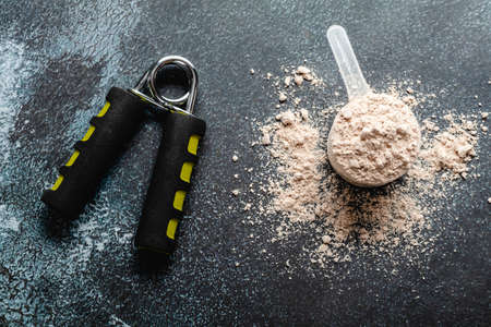 Scoops filled with protein powders for fitness nutrition to start trainingの写真素材
