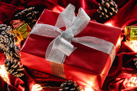Christmas gift and decoration on red velvetの写真素材