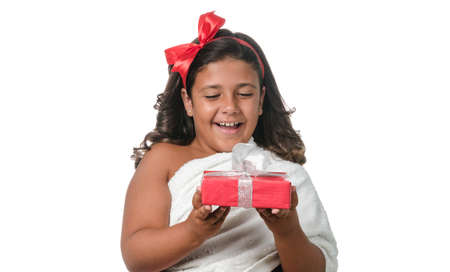 Happy little girl with a gift on white backgroundの写真素材