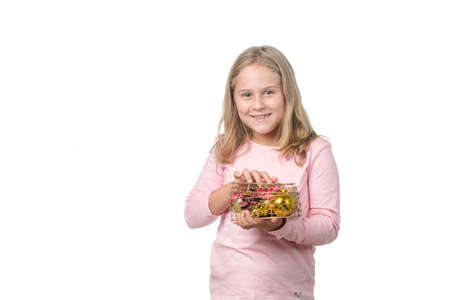 Blonde little girl with a heart-shaped gift on white backgroundの写真素材