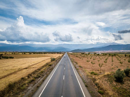 Aerial View Of Straight Tarred Road Through Guadix, Granada. In the background Sierra Nevadaの写真素材