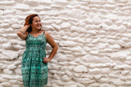 Young woman posing on the background of old brick wall. Outdoors, lifestyle.の写真素材