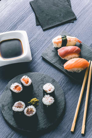 Sushi on wood table. Elegant japanese restaurant. Retro styleの写真素材