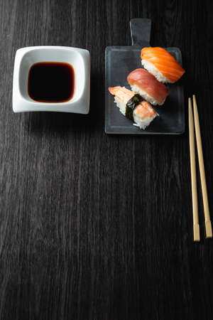 Nigiri sushi on wood table in a japanese restaurant. Copy space and top viewの写真素材