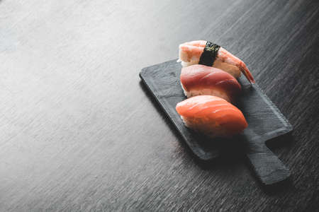 three different nigiris. Salmon, tuna and prawn. Copy spaceの写真素材