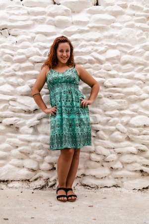 Young woman posing on the background of old brick wall. Outdoors, lifestyle.の写真素材