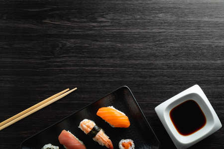 Elegant sushi on wood table. Some Nigiri, with soy sauce and chopstickの写真素材