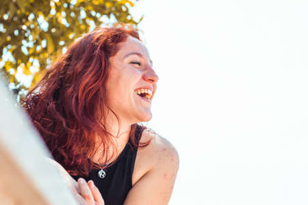 Happy redhead girl in a park, Close up shotの写真素材