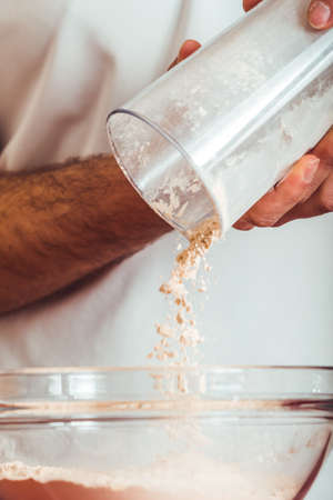 Man doing the seitan cooking process at home. How to prepare seitan at home vegan meatの写真素材