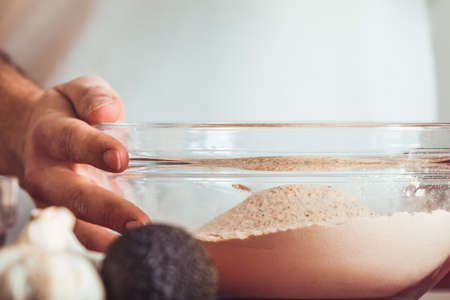 Man doing the seitan cooking process at home. How to prepare seitan at home vegan meatの写真素材