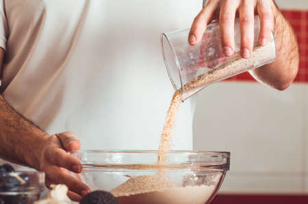 Man doing the seitan cooking process at home. How to prepare seitan at home vegan meatの写真素材