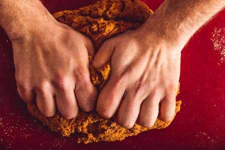 Man doing the seitan cooking process at home. How to prepare seitan at home vegan meatの写真素材