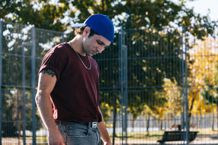 Young cool man break dancer standing in park. Tattoo on bodyの写真素材