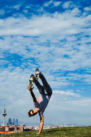 B-boy performing some moves. Breakdancer in modern city backgroundの写真素材
