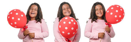Little girl smiling with red balloon on white backgroundの写真素材
