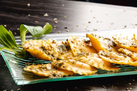 Italian stuffed pasta ravioli with pesto sauceの写真素材