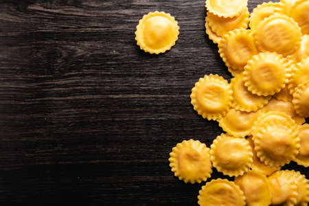 Cooking italian ravioli on wooden table. Top View with Copy Space.の写真素材