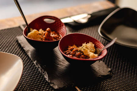 fusion cuisine served in a restaurant, Spanish meat tapa in sauce with potatoの写真素材