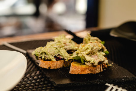 fusion cuisine served in a restaurant, Spanish pincho with salad, curry sauce and chicken
