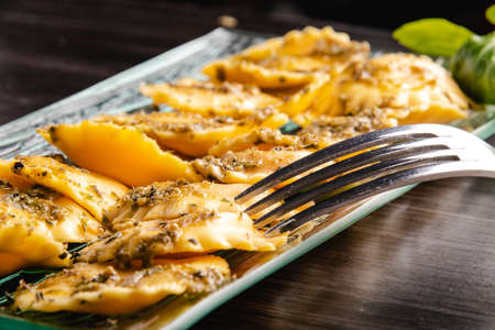 Italian stuffed pasta ravioli with pesto sauceの写真素材