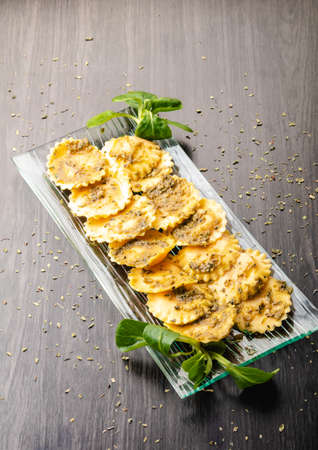 Italian stuffed pasta ravioli with pesto sauceの写真素材