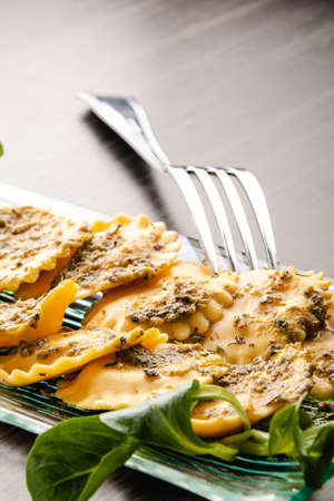 Italian stuffed pasta ravioli with pesto sauceの写真素材