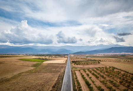 Aerial View Of Straight Tarred Road Through Guadix, Granada. In the background Sierra Nevadaの写真素材