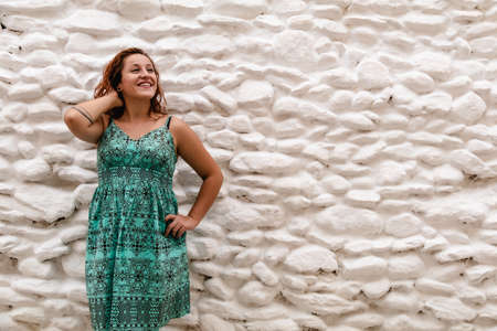 Young woman posing on the background of old brick wall. Outdoors, lifestyle.の写真素材