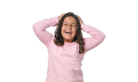 Funny little girl looking to the camera on white backgroundの写真素材