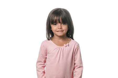 Portrait of a little brunette girl posing isolated on white background.の写真素材
