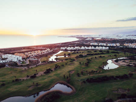 Aerial view of tropical golf course at sunsetの写真素材