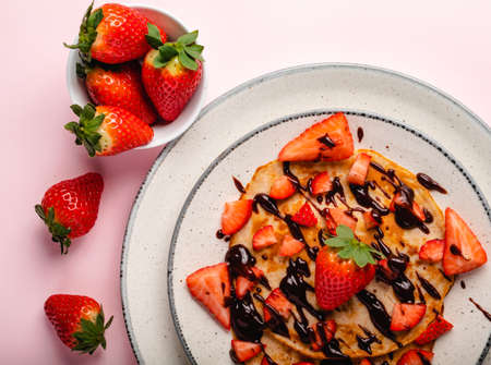 Pancakes with fresh strawberry on a blue wooden backgroundの写真素材