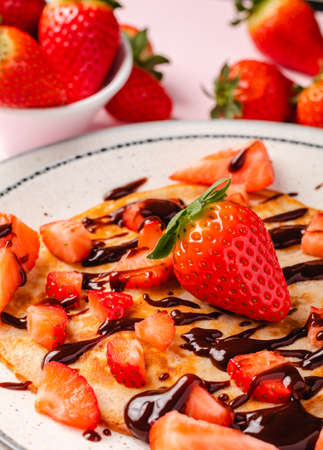 Pancakes with fresh strawberry on a blue wooden backgroundの写真素材
