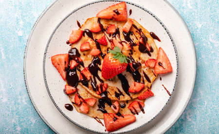 Pancakes with fresh strawberry on a blue wooden backgroundの写真素材