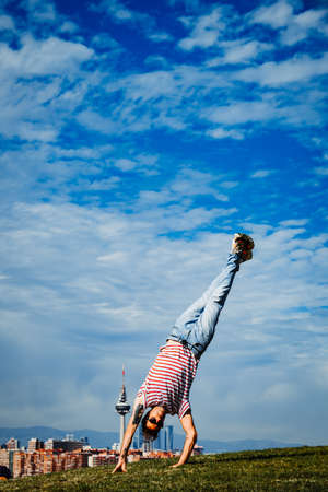 B-boy performing some moves. Breakdancer in modern city backgroundの写真素材