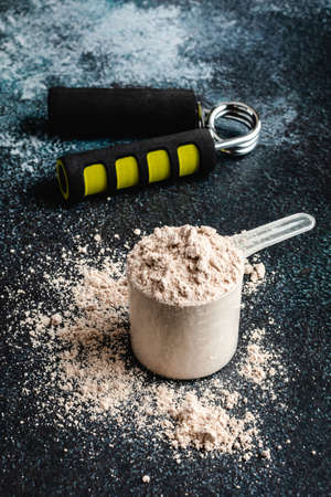 Scoops filled with protein powders for fitness nutrition to start trainingの写真素材