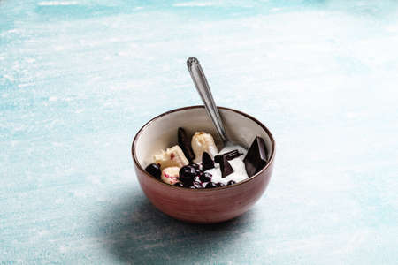 Yogurt with banana, blueberries and chocolate ready to eat in a bowlの写真素材