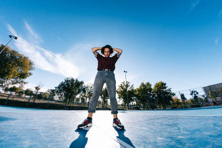 Young cool man break dancer standing in park. Tattoo on bodyの写真素材