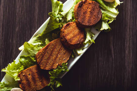 Cooking vegan food. Seitan is vegan meat for veggie burgerの写真素材