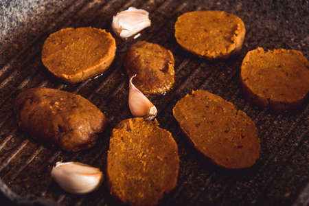 Cooking vegan food. Seitan is vegan meat for veggie burgerの写真素材