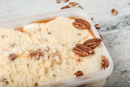 ice cream with ground nuts on white concrete table