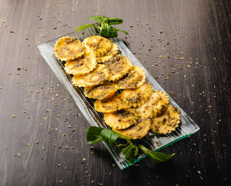 Italian stuffed pasta ravioli with pesto sauceの写真素材