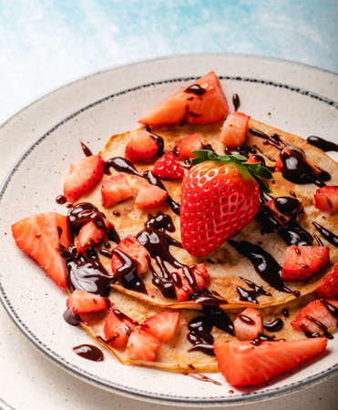 Pancakes with fresh strawberry on a blue wooden backgroundの写真素材