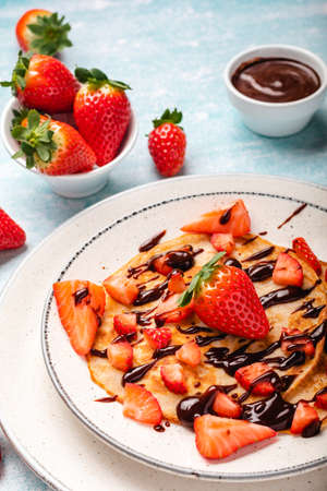Pancakes with fresh strawberry on a blue wooden backgroundの写真素材
