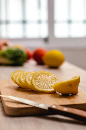 Lemon cut on a wooden table in the kitchenの写真素材