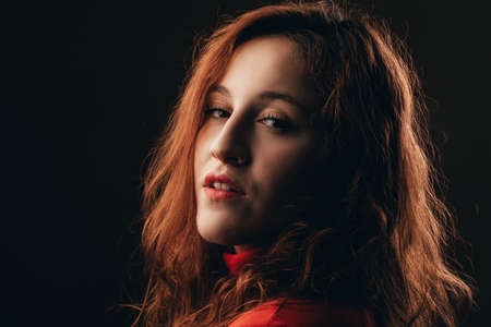 Glamor woman dark portrait, beautiful female looking to cameraの写真素材