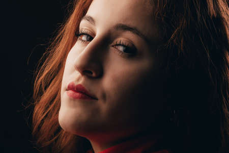 Glamor woman dark portrait, beautiful female looking to cameraの写真素材