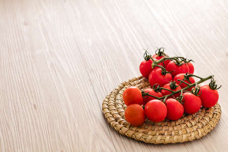 Small red cherry tomatoes on rustic backgroundの写真素材