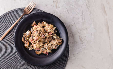Scrambled eggs with mushrooms and ham. Spanish dish. copy spaceの写真素材
